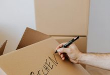 Moving House: Some Simple Ways To Make It Easier Moving House / Photo credit: https://www.pexels.com/photo/crop-man-writing-on-carton-box-word-kitchen-4506265/