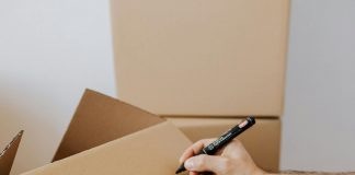 Moving House: Some Simple Ways To Make It Easier Moving House / Photo credit: https://www.pexels.com/photo/crop-man-writing-on-carton-box-word-kitchen-4506265/